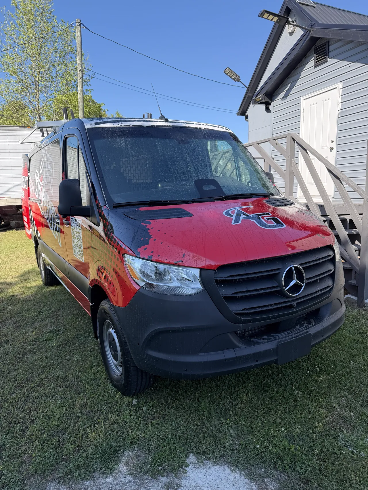 Air Georgia Mercedes Sprinter van, front view, wrapped in red, black and navy