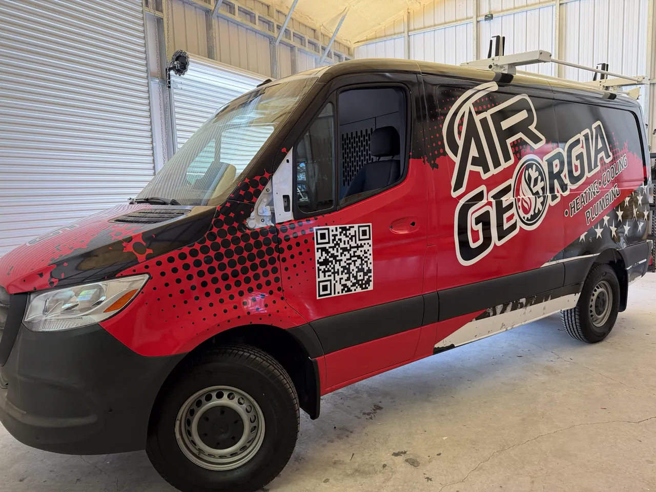 Air Georgia van, driver-side front quarter, parked indoors