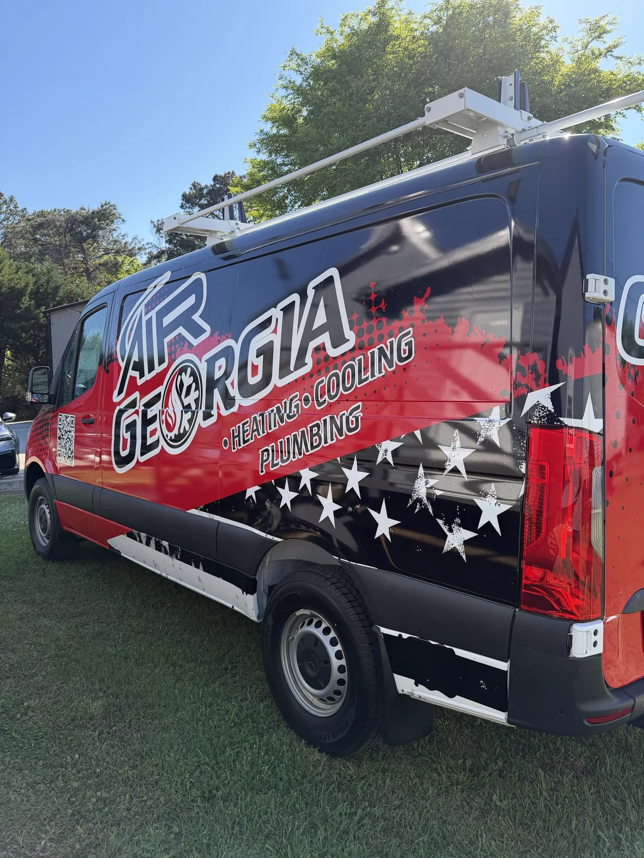 Air Georgia van, driver-side rear quarter, with 'Heating, Cooling, Plumbing' and a stars-and-stripes graphic
